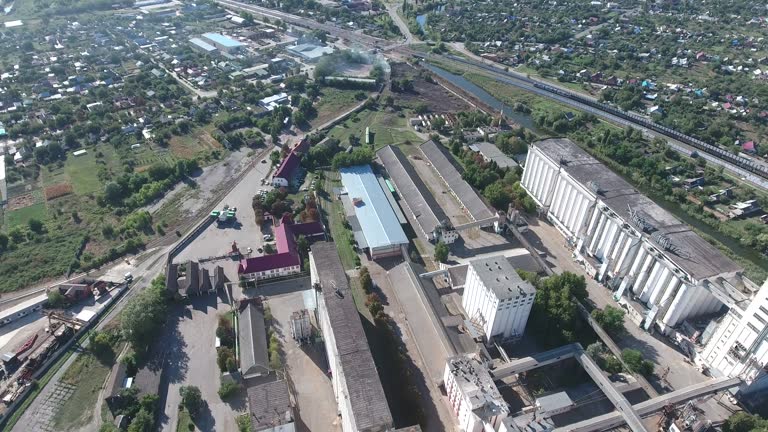 Grain terminal. The old Soviet grain elevator. Top view of a silo elevator. Aerophotographing industrial object.