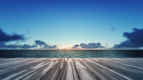 istock wooden deck with sunrise over sea scenery 1055864714