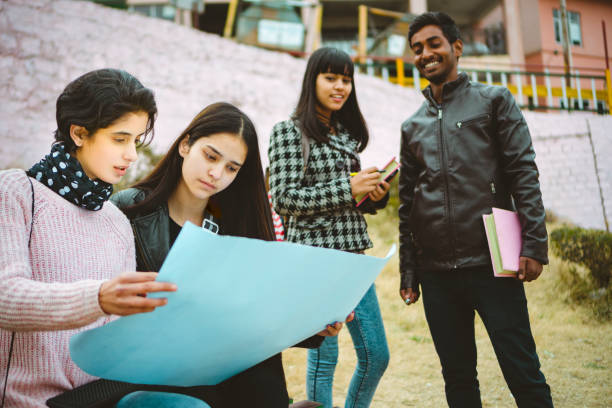 istock Female college students discuss project together. 1055865614