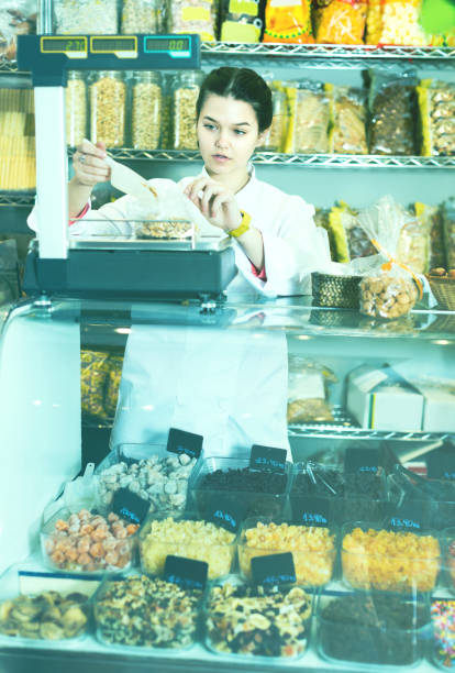 istock Young female is weighing walnuts 1055865626