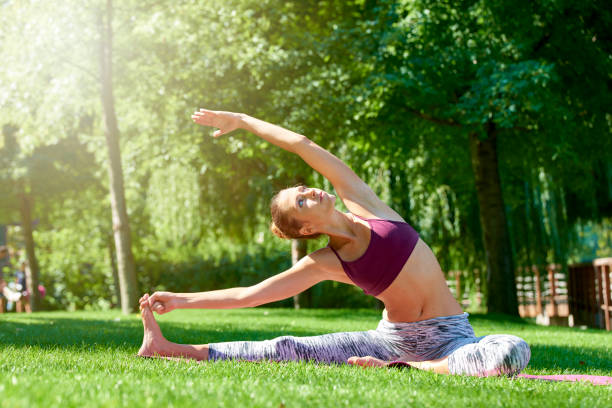 istock Beatiful young woman practicing yoga outdoor 1055872822