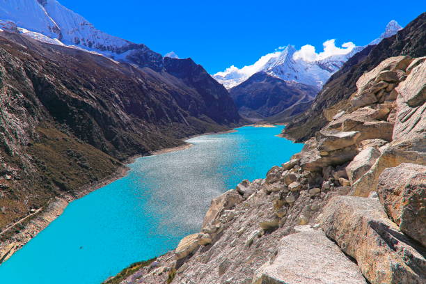 istock Small boat on Paron lake in Cordillera Blanca, Peruvian Andes - Ancash, Peru 1055873816