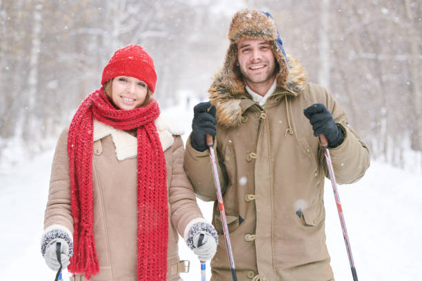 istock Young Couple Skiing Together 1055874080