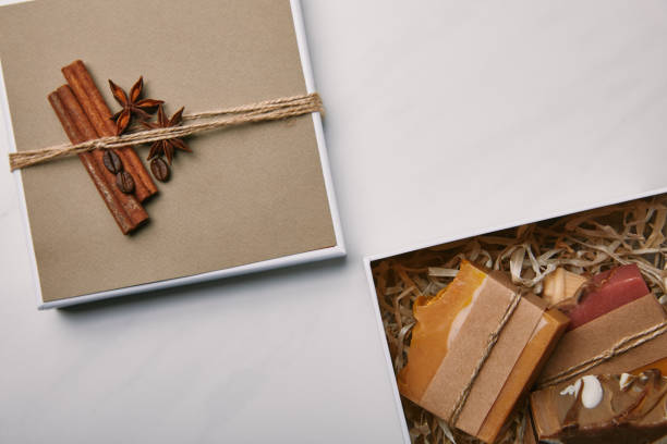 istock top view of decorated gift box with handmade soap inside on white marble surface 1055874118