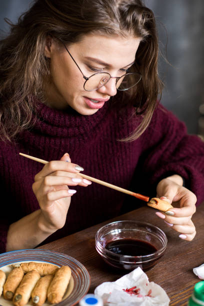 Positive lady painting Halloween cookies
