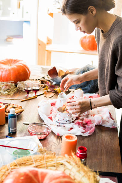 istock Creative designer choosing Halloween decoration placement for sh 1055874398