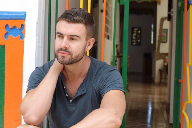 istock Man deep in thoughts at home entrance 1055874754