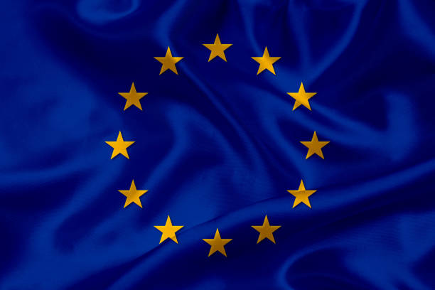 Low Angle View Of Flags Waving Against Clear Blue Sky