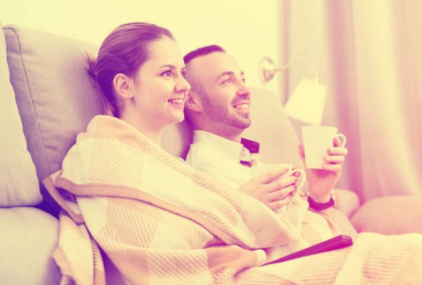istock Couple is watching TV on the sofa 1055876162