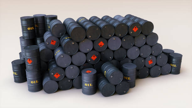 istock Top view on a stack of dark oil drums with labels and warning signs 1055876526