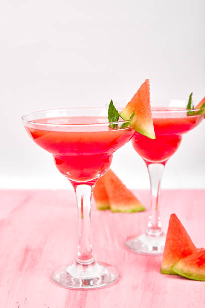 istock Watermelon margarita cocktail on white background. Fresh watermelon lemonade 1055877208
