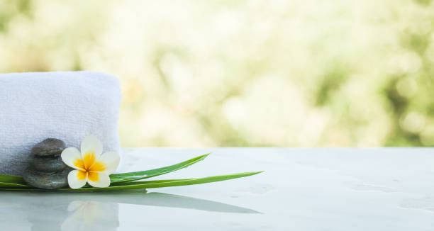 istock Spa objects and stones for massage treatment on white sunlight  background. 1055877266