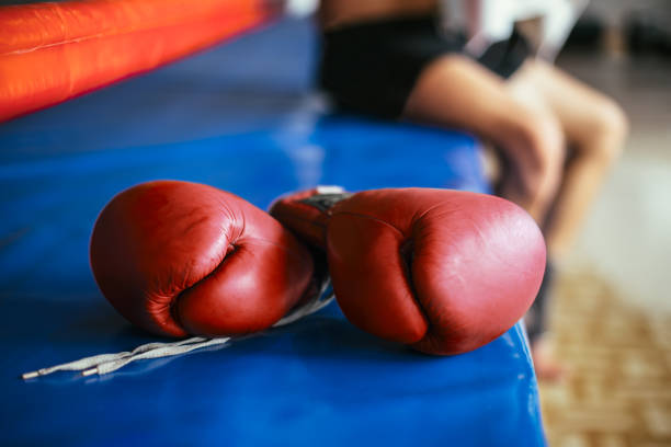 istock Red boxing gloves on boxing ring 1055879790