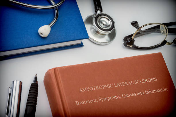 titled book amyotrophic lateral sclerosis along with medical equipment, conceptual image - esclerose lateral amiotrófica imagens e fotografias de stock