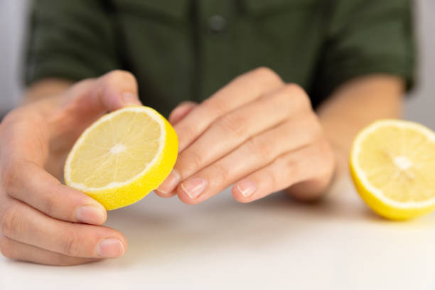istock Manicure, woman cleans her nails with lemon. 1055881150