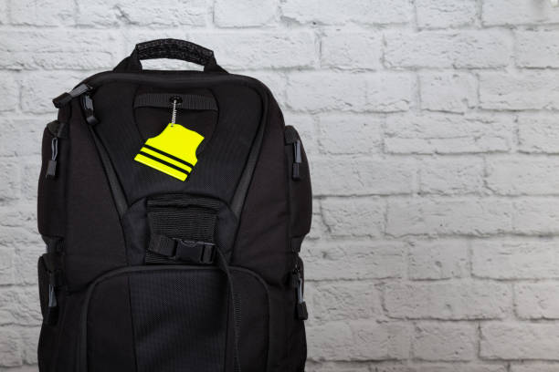 Black backpack with pedestrian safety reflectors with copy space stock photo