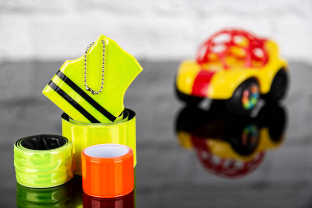 Pedestrian and children safety concept. Set of reflectors and blurred toy car stock photo