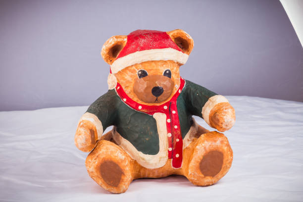 istock bear dressed for Christmas is taking a photo 1055883988