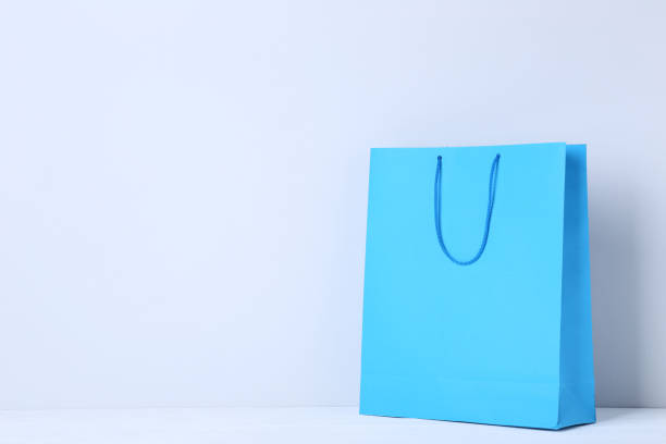 istock Blue shopping bag on gray background 1055887226