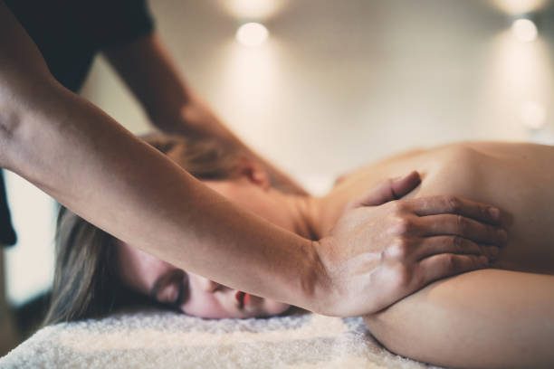 istock Masseur treating patient with therapeutic massage 1055890768