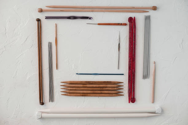 istock Variety of rochet hooks and knitting needles in different sizes on white background. 1055892080