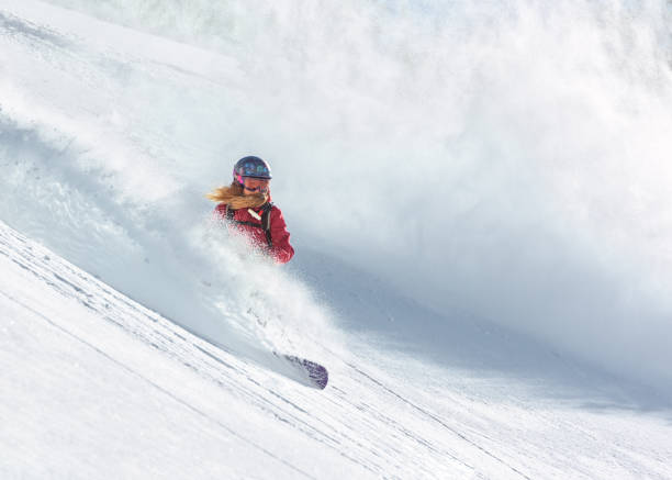 piloto de snowboard feminino correndo na neve fresca em pó - freeride - fotografias e filmes do acervo