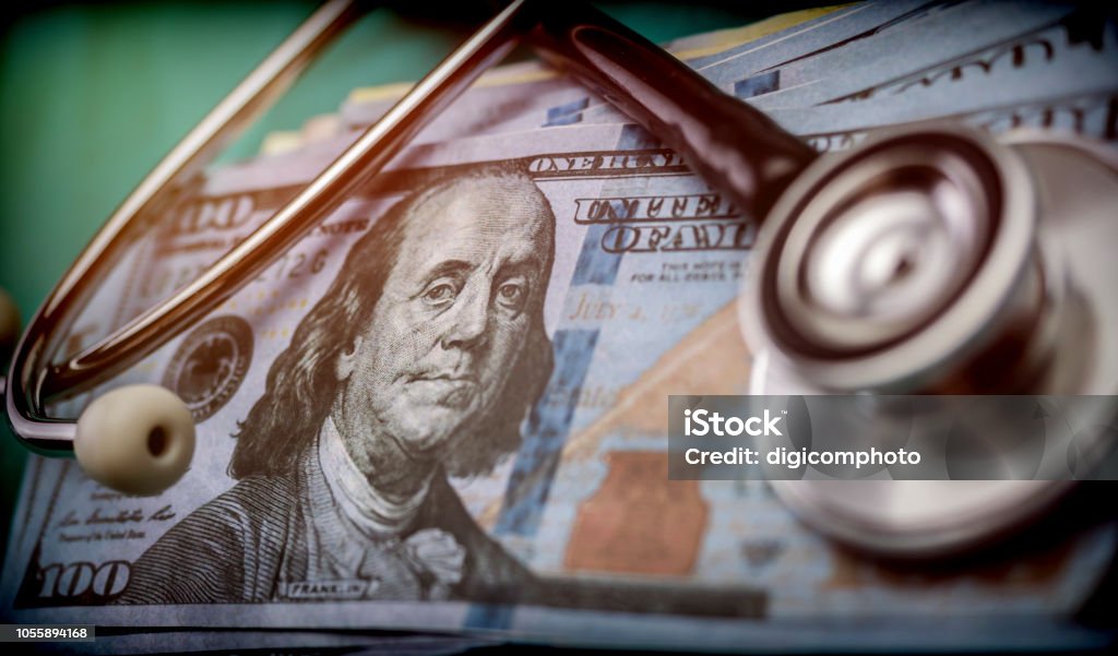 phonendoscope on American tickets, concept of sanitary copayment Poverty Stock Photo