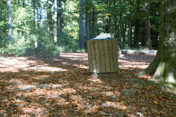 istock Full trash bin in the middle of the forest 1055895900