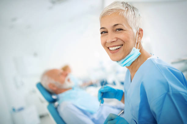 улыбающаяся женщина-стоматолог. - smiling dentist office dentists chair women стоковые фото и изображения