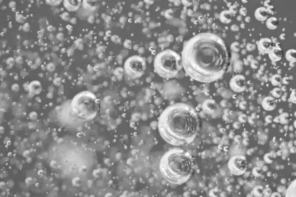 Bubbles of oxygen under water. Water black and white structure. Macro.