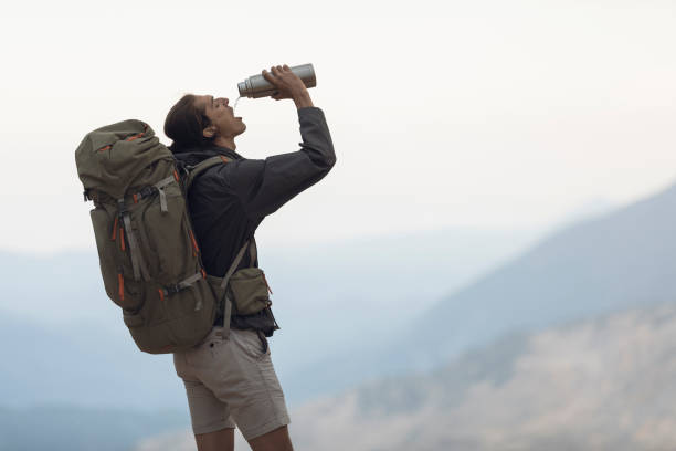 istock Traveler Stops to Take a Drink 1055900474