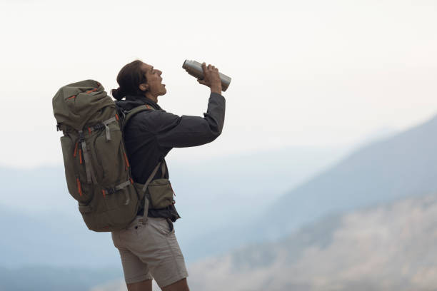 istock Traveler Stops to Take a Drink 1055900758