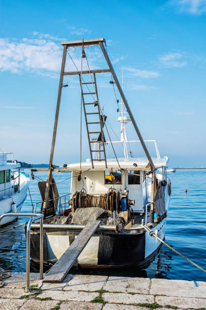istock Fishing boat with nets in port, Porec, Croatia 1055900762