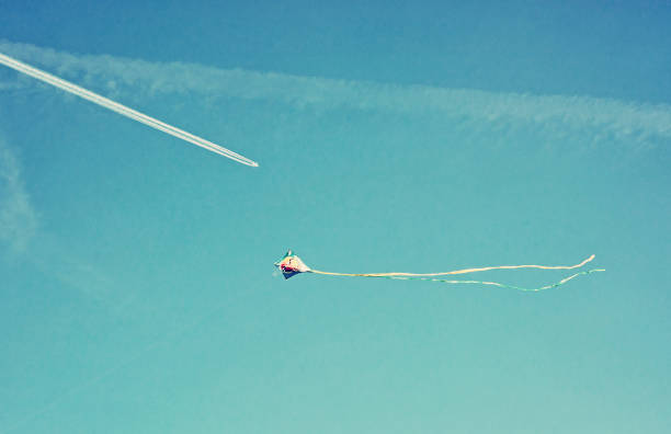 istock Flying colorful kite kite and airplane 1055900874