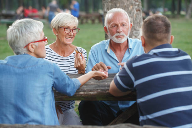istock Senior people playing cards game 1055901560