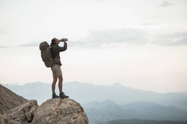 istock Traveler Stops to Take a Drink 1055901754