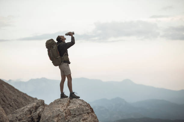 istock Traveler Stops to Take a Drink 1055901772