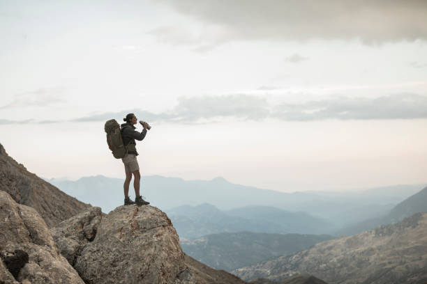istock Traveler Stops to Take a Drink 1055902966