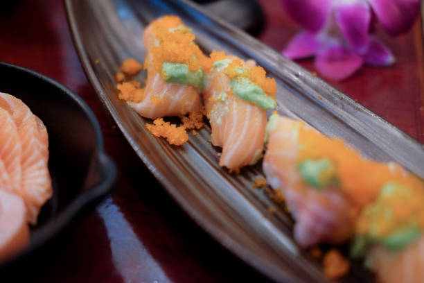 istock Sushi roll with salmon. Selective focus. Close up of sashimi sushi set 1055902978