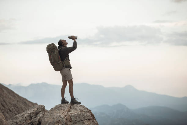 istock Traveler Stops to Take a Drink 1055903052