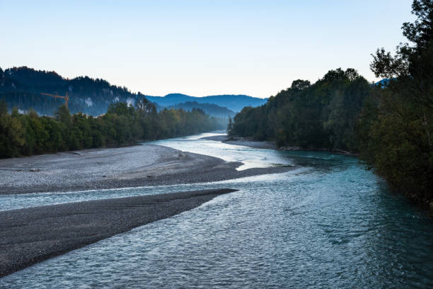 istock River in small Austrian city. Alps mountains at the morning 1055904428