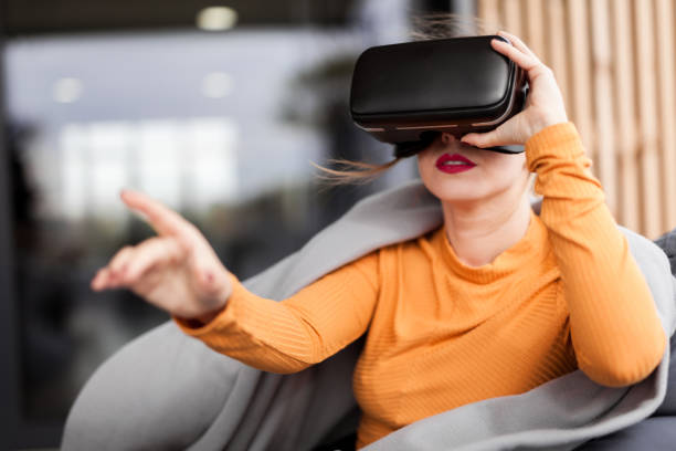 istock Future is now, young pretty woman use virtual reality headset, digital 3d world 1055905704