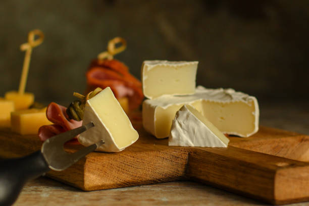 istock camembert cheese (cheese platter delicacies) groceries. Brie cheese top view. 1055906280