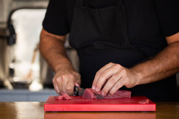 istock Crop chef slicing fresh tuna 1055906702
