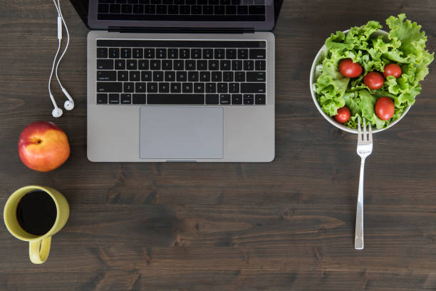 istock Overhead view of desk with laptop 1055909790