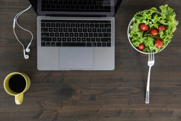 istock Overhead view of desk with laptop 1055910484