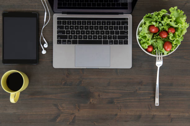 istock Overhead view of desk with laptop and office accessories 1055910844