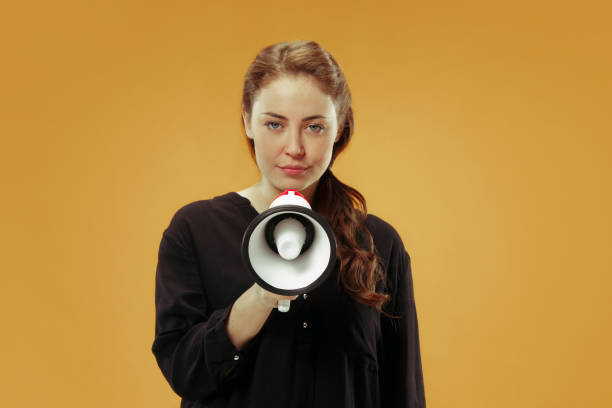 istock Woman making announcement with megaphone 1055912626