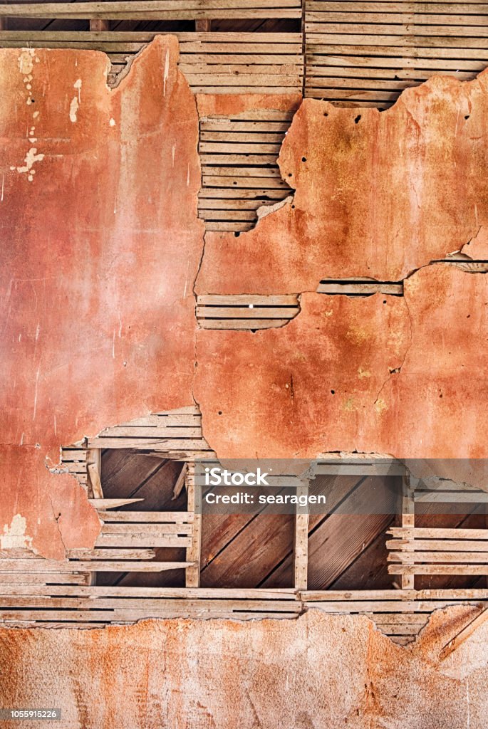 Plaster And Lathe Background An architectural background results from the cracked plaster and lathe on an old red wall in a ghost town schoolhouse in Govan, Washington. Lathe Stock Photo