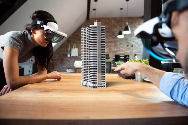 Augmented reality project Two people working on virtual 3d building by using AR glasses. augmented reality app stock pictures, royalty-free photos & images